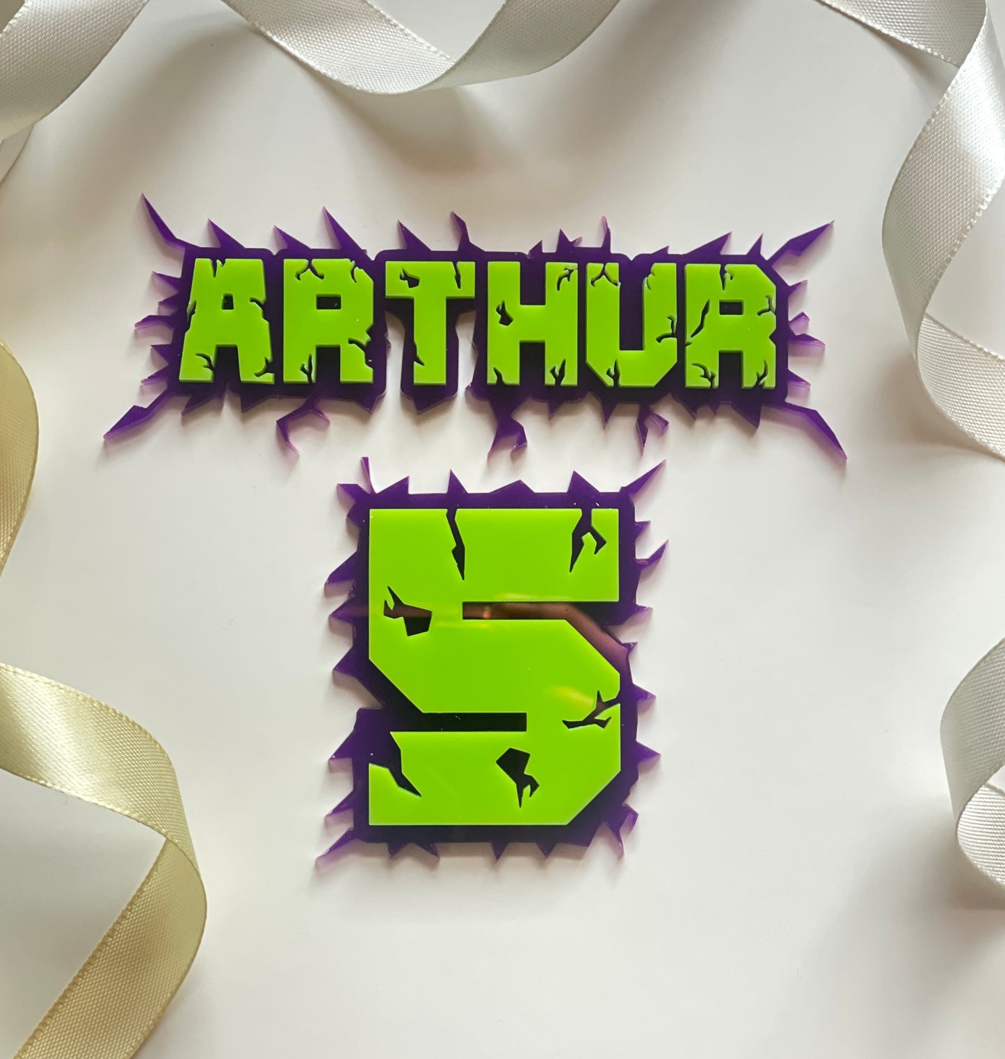 Green and purple acrylic name and age charm. Superhero themed.
