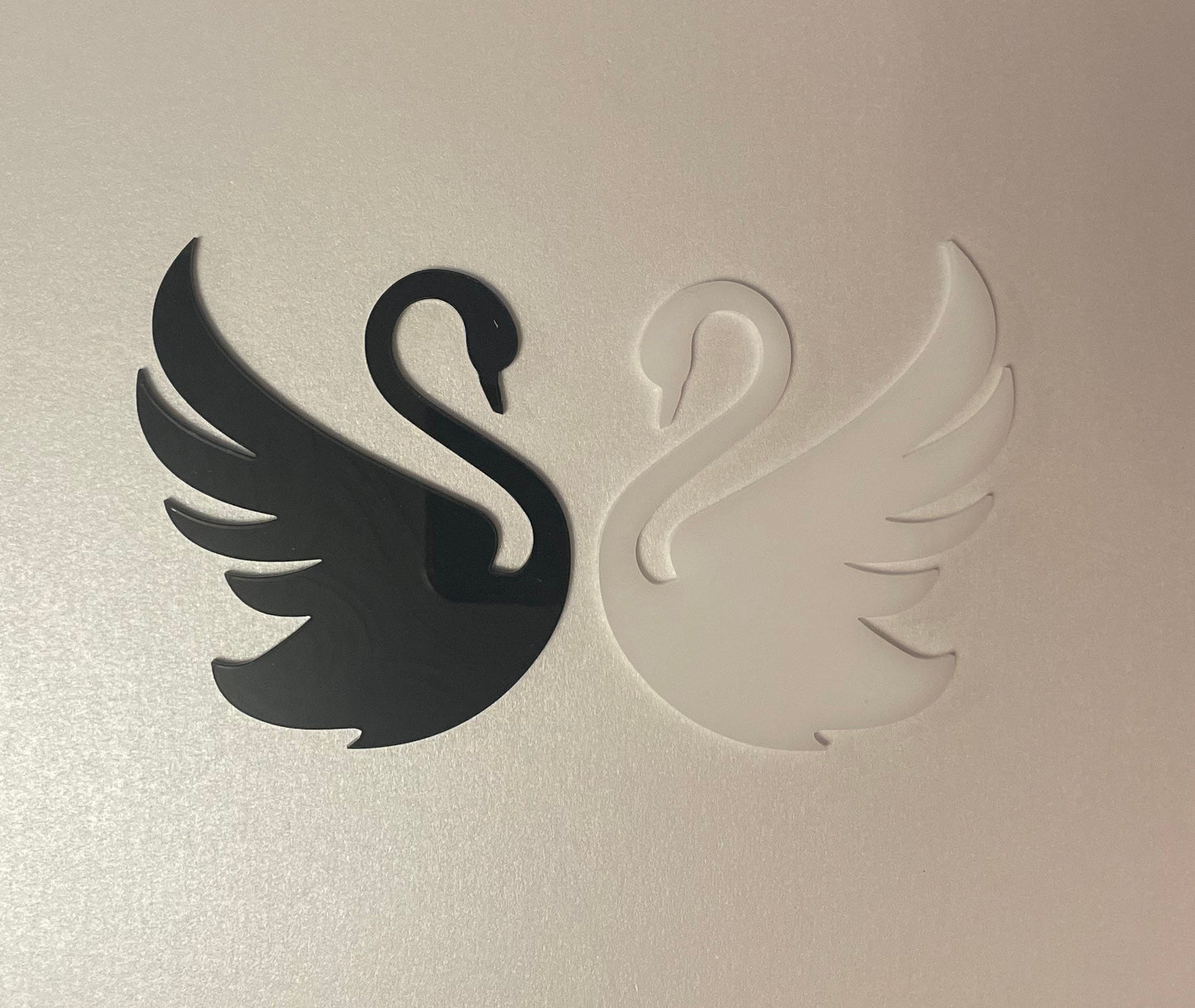 Black and White Acrylic Swans . Approx 3.5 inches wide. Good and Evil theme. Edible icing.