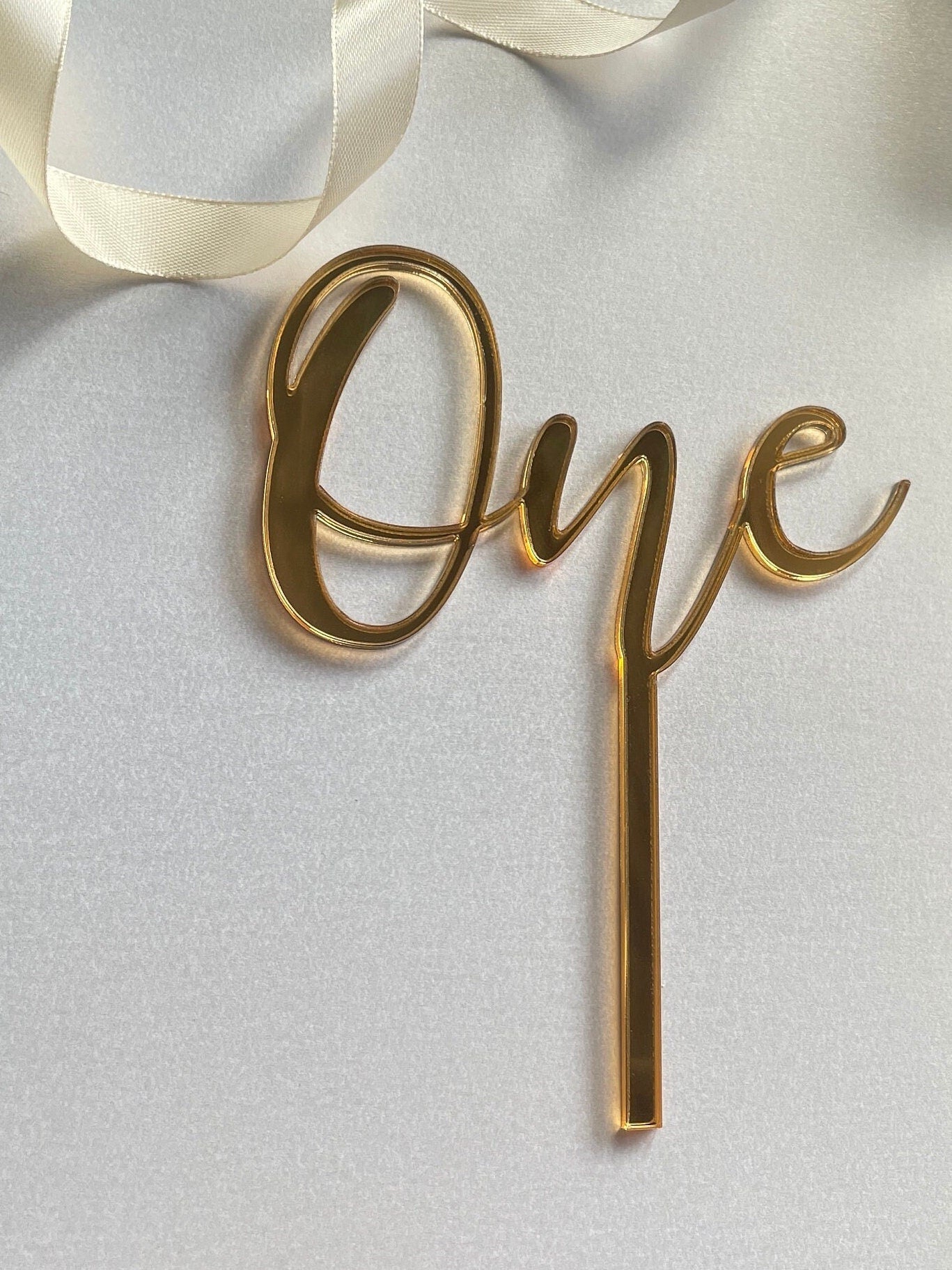 One cake topper. Mirrored acrylic topper. One cake charm