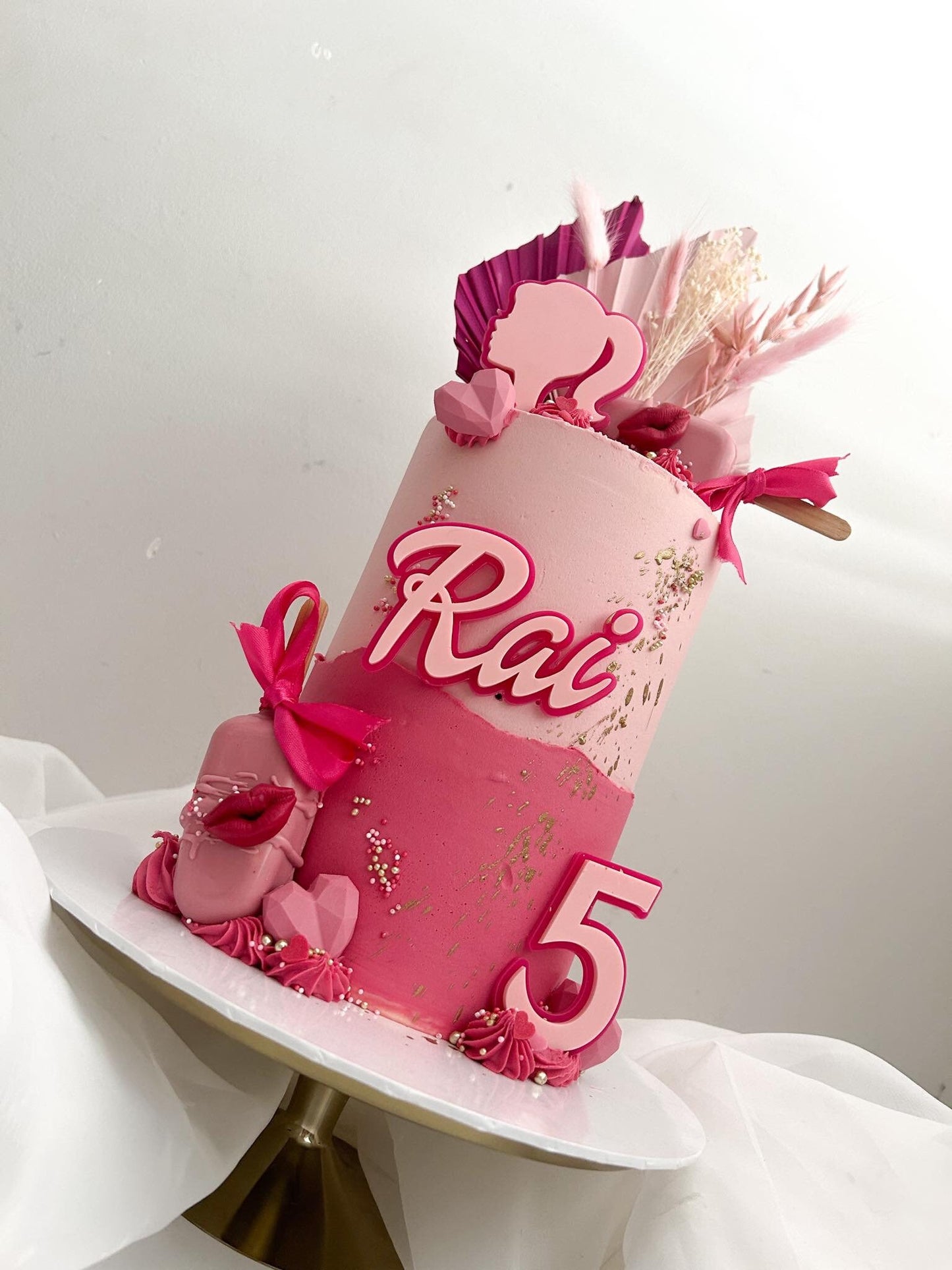 Doll themed pink acrylic cake charms.