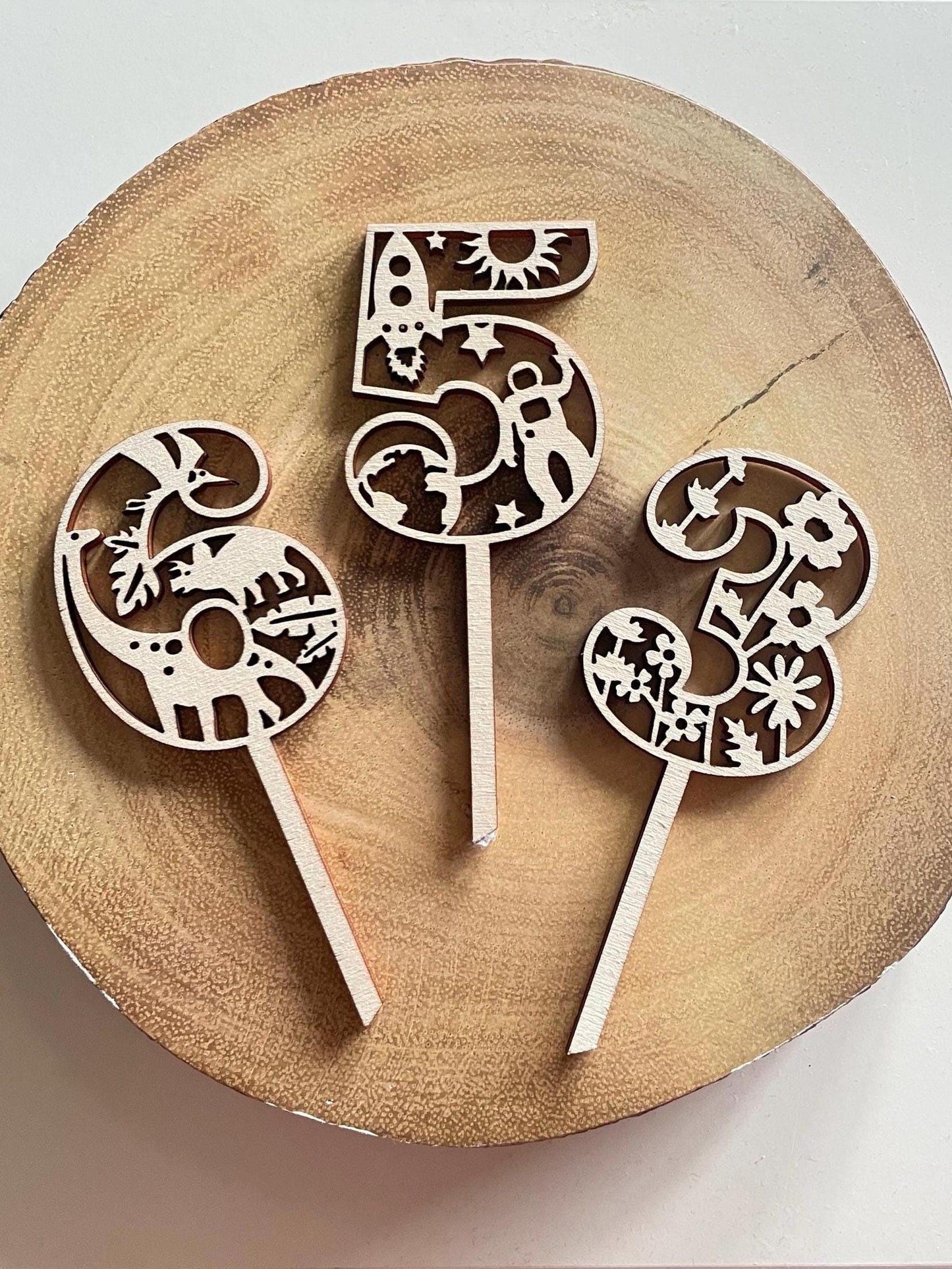 Customised wooden number cake toppers. Dinosoar / Space / Flowers