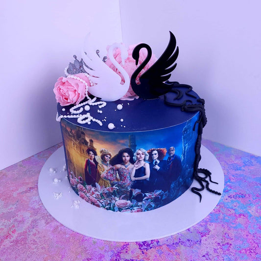 Black and White Acrylic Swans . Approx 3.5 inches wide. Good and Evil theme. Edible icing.