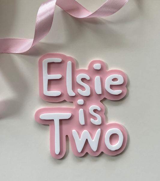 Cute name is age charm. Pink and white acrylic birthday cake charm