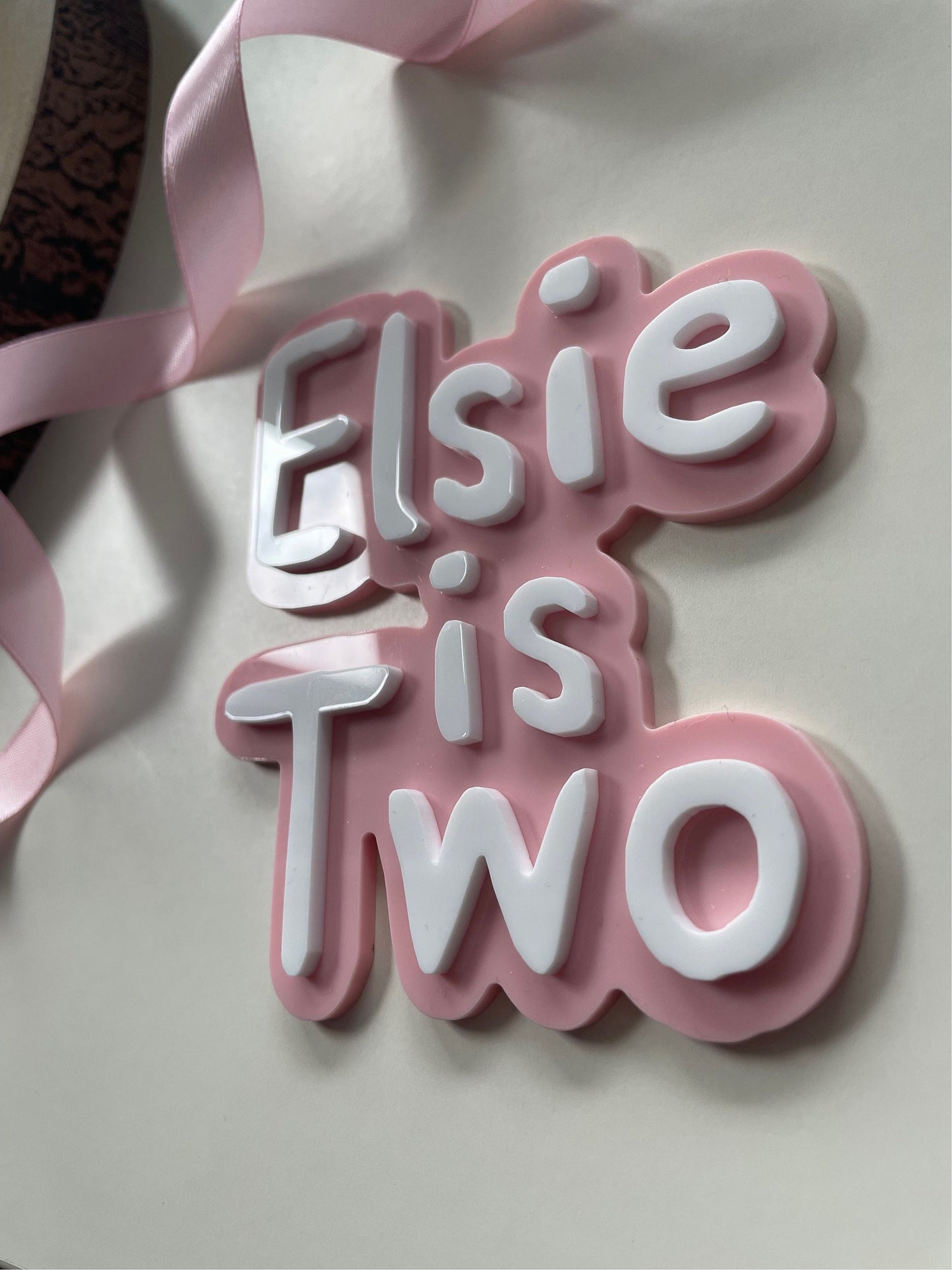 Cute name is age charm. Pink and white acrylic birthday cake charm