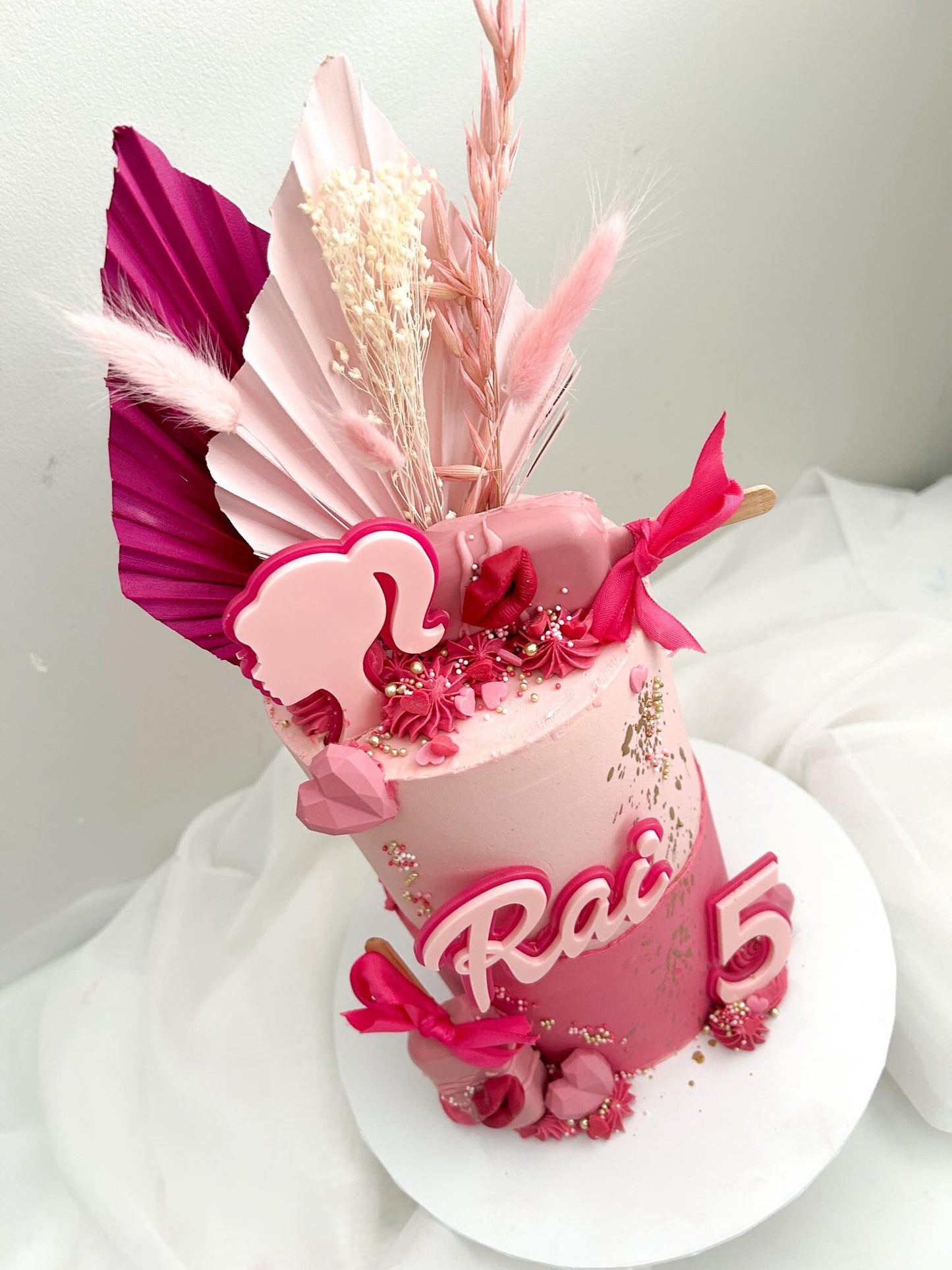 Doll themed pink acrylic cake charms.
